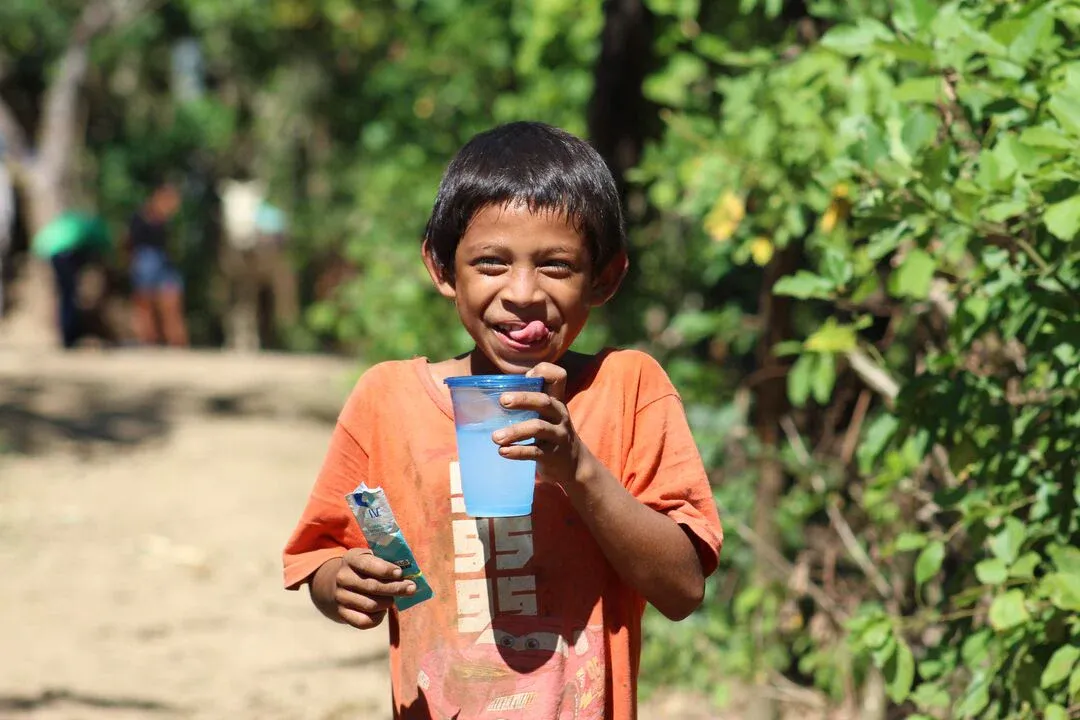 Boy drinking water in Latin America