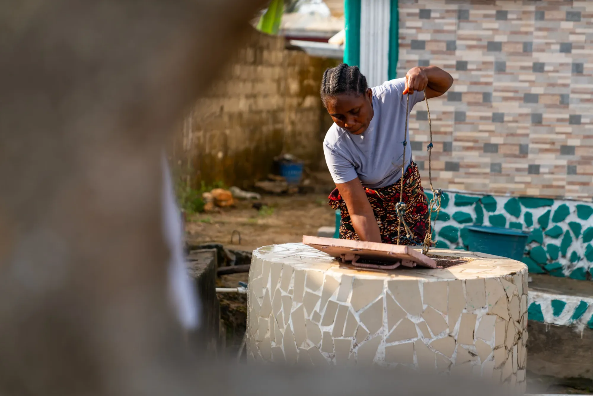 a woman in Latin America getting water from a well