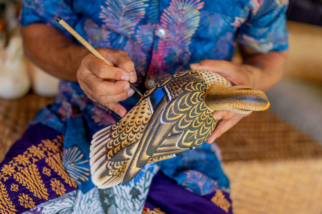 Artisan hand painting a duck